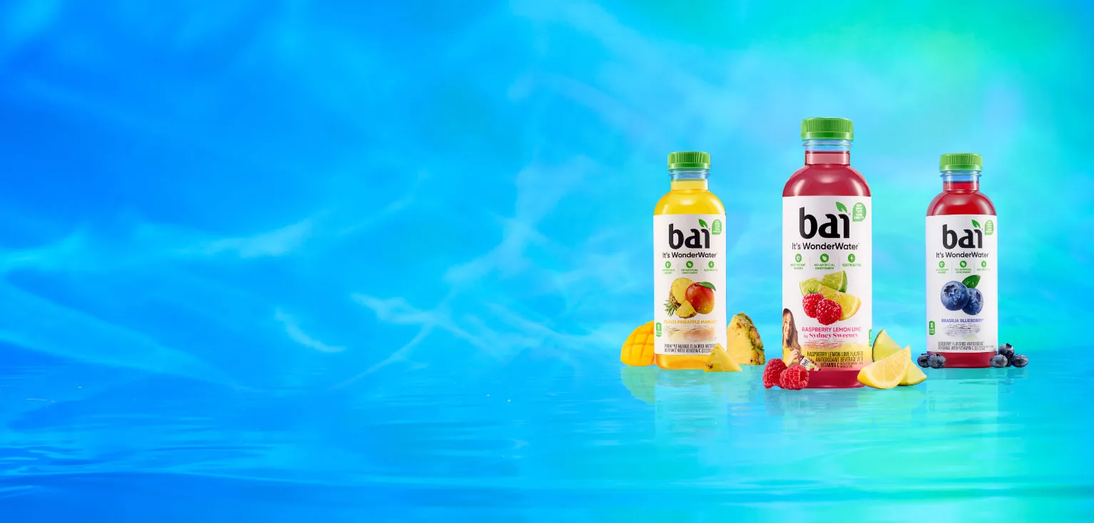 Bai Bottles next to fruit based on their respective flavors