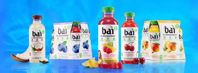 Bai Bottles and 6 packs next to fruit based on their respective flavors